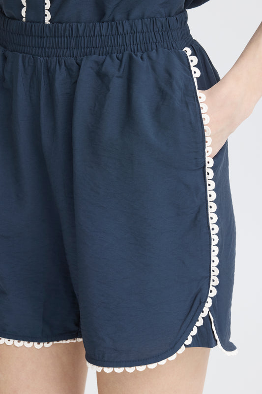 lightweight navy shorts with scalloped dge and boxy fit with elasticated waist and contrast trim