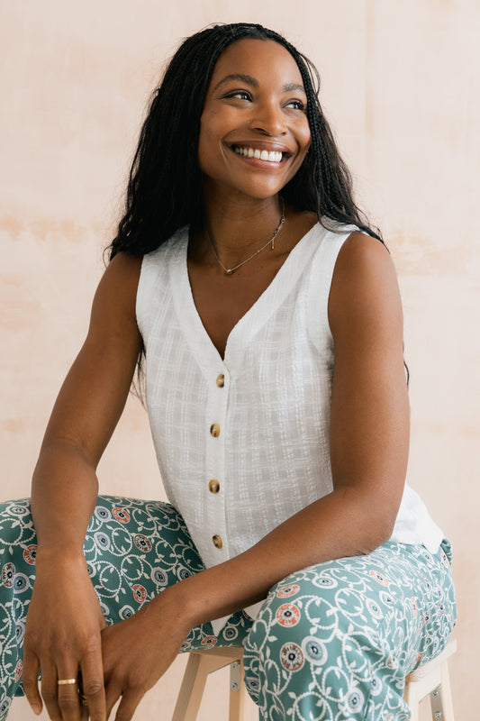 A modern spin on a classic vest, with a V-neckline and button-through detail. Made from textured organic cotton blended with viscose, creating a soft and breathable, summer-weight seersucker fabric.
