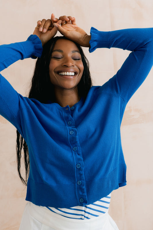 Cobalt blue organic cotton women's cardigan with ruffle detail down the button front