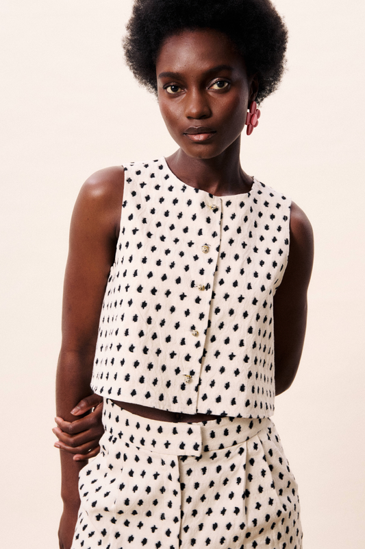 ecru crop top with black polka dots, stone-button front in a cotton/linen mix fabric.