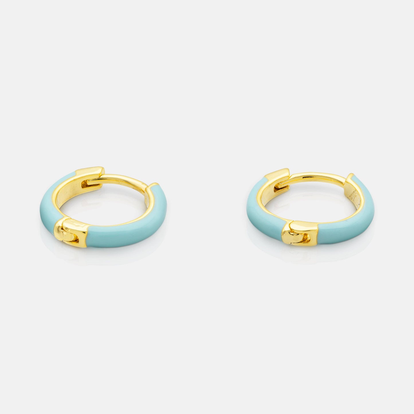 Pair of gold hoop earrings with light blue enamel on a white background